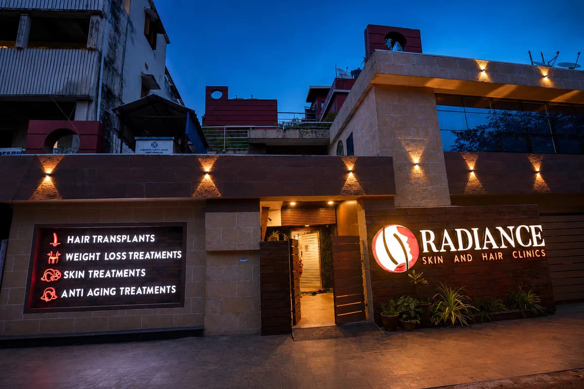 Exterior board of Radiance Skin and Hair Clinics at dusk